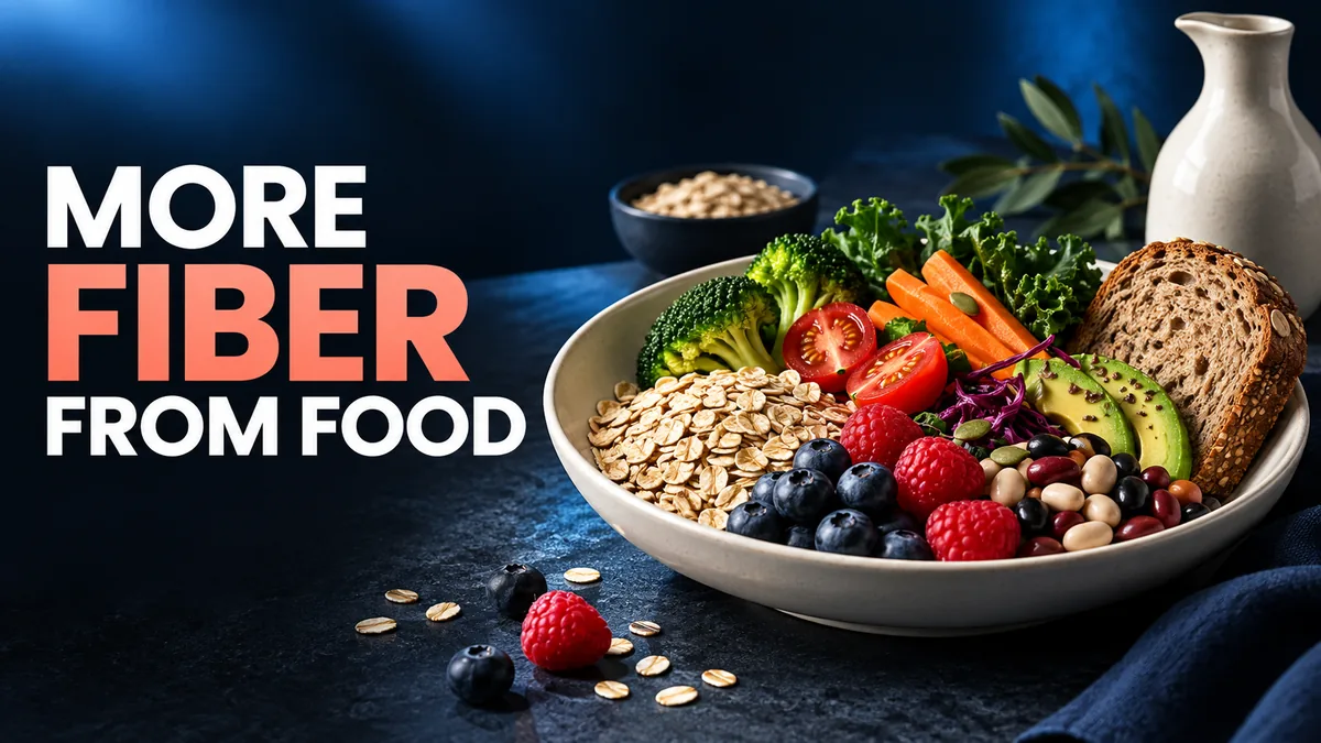 MORE FIBER FROM FOOD. An ivory bowl holds oats, berries, beans, vegetables and whole grain bread against a navy background.